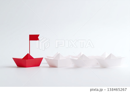 Red paper boat leads a fleet of white vessels, symbolizing leadership and a clear direction on a light background. 138465267
