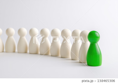 Green figure stands out among white figures in leadership demonstration on clean background. Green figure stands out among white figures in leadership demonstration on clean background. 138465306