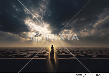 Woman stands before a mysterious maze under a dramatic cloudy sky with sun rays shining through, conveying a sense of challenge. 138465352
