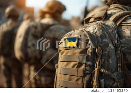 Ukrainian soldiers stand in formation with the national flag patch visible on their military uniforms, symbolizing patriotism and defense. 138465370