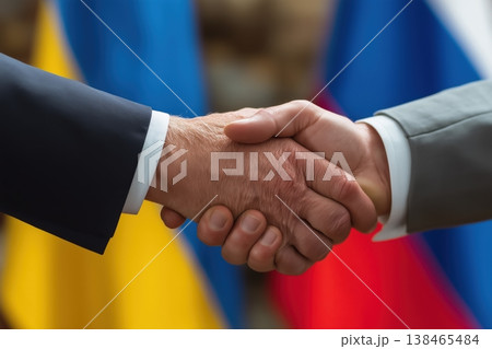 Business handshake demonstrates agreement and partnership with Ukraine and Russia flags symbolizing international accord. 138465484