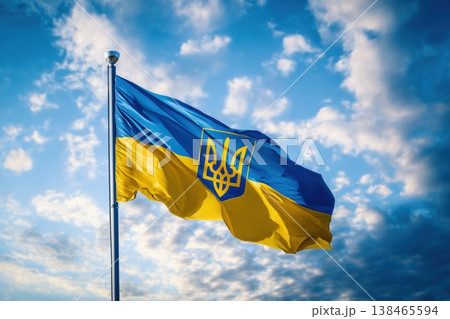 The national flag of Ukraine waves gently against a bright blue sky filled with fluffy white clouds, showcasing patriotism The national flag of Ukraine waves gently against a bright blue sky filled with fluffy white clouds, showcasing patriotism 138465594
