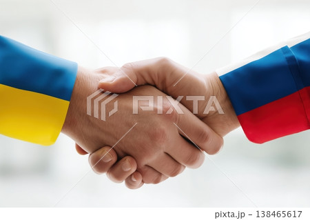 Hands shake in a gesture symbolizing potential peace between Ukraine and Russia, offering a glimmer of hope for resolution. 138465617