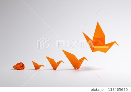 Orange origami cranes symbolize transformation, growth, and the journey of development on a plain background. Orange origami cranes symbolize transformation, growth, and the journey of development on a plain background. 138465650