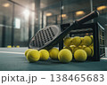 Get ready to play padel with fresh tennis balls and a sleek racket on the court today 138465683