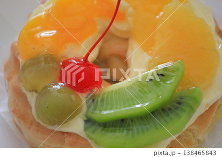 Delicious fruit tart with glazed cherry kiwi and orange slices for sweet bakery dessert concept Delicious fruit tart with glazed cherry kiwi and orange slices for sweet bakery dessert concept 138465843