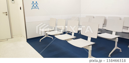 Empty white chairs in a waiting room at a clinic or government agency. Concept of medicine and comfort in service. Empty white chairs in a waiting room at a clinic or government agency. Concept of medicine and comfort in service. 138466318