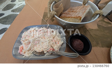 Crab salad, bread and olive paste on a restaurant table Crab salad, bread and olive paste on a restaurant table 138466760