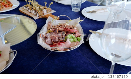 Meat and vegetable appetizers are beautifully arranged on serving platters, ready to be enjoyed at a catered event, showcasing a variety of culinary delights Meat and vegetable appetizers are beautifully arranged on serving platters, ready to be enjoyed at a catered event, showcasing a variety of culinary delights 138467159