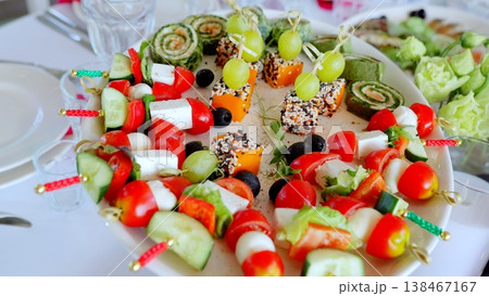 Beautifully decorated banquet table featuring an array of colorful snacks and appetizers, including cheese, vegetables, and grapes, perfect for any celebration Beautifully decorated banquet table featuring an array of colorful snacks and appetizers, including cheese, vegetables, and grapes, perfect for any celebration 138467167