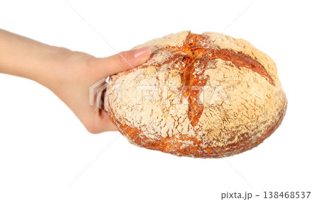 Female hand holding artisan sourdough bread loaf isolated on light background 138468537