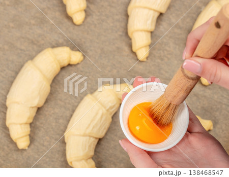 Egg wash for raw croissants Egg wash for raw croissants 138468547