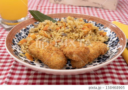 Spiced Rice with Golden Fried Fish Strips Spiced Rice with Golden Fried Fish Strips 138468905