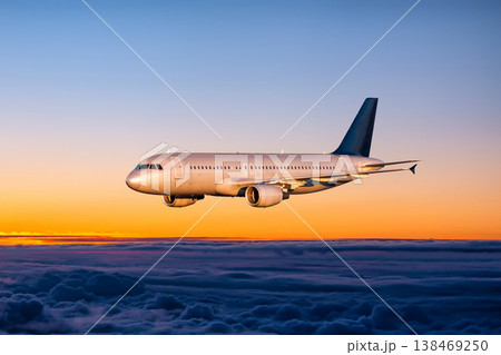 Passenger plane flying in the sunset sky Passenger plane flying in the sunset sky 138469250