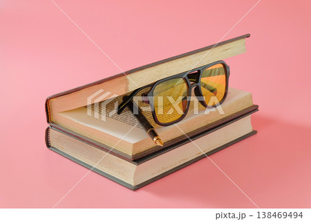 Eyeglasses inside open book on color background.knowledge and education theme. Eyeglasses inside open book on color background.knowledge and education theme. 138469494