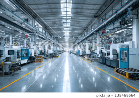 A clean and modern factory hall features interconnected machines and automated workflows. The space is designed for efficient production with a focus on technology and automation 138469664
