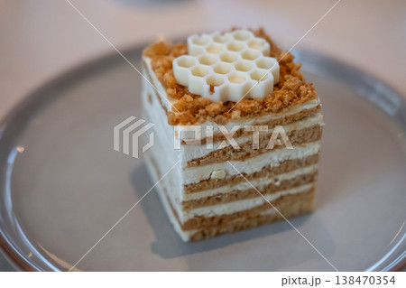 Medovik, Russian and Soviet honey cake served on plate in the cafe 138470354