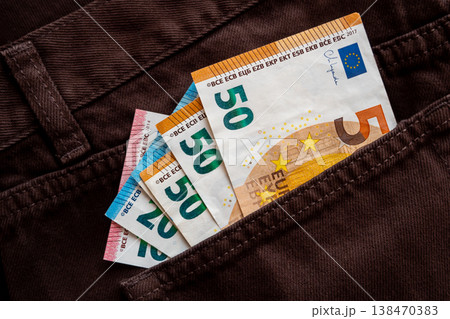Brown jeans with paper euro money for shopping. Cash bills in the pants pocket for commerce concept. Brown jeans with paper euro money for shopping. Cash bills in the pants pocket for commerce concept. 138470383