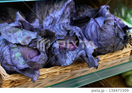 Fresh purple cabbage is arranged in a woven basket at a market stand Fresh purple cabbage is arranged in a woven basket at a market stand 138471509