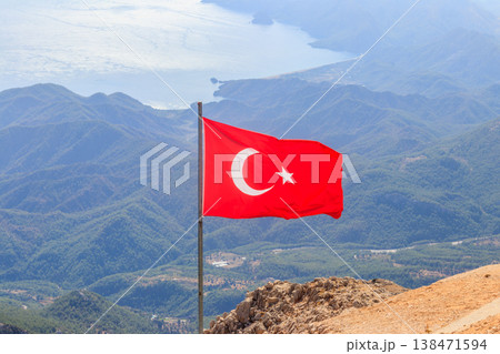 Waving flag of Turkey against mountains and sea 138471594