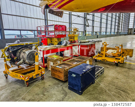 Aircraft engine maintenance in a hangar. Jet turbine repair and service for the aviation industry. Aircraft engine maintenance in a hangar. Jet turbine repair and service for the aviation industry. 138472587