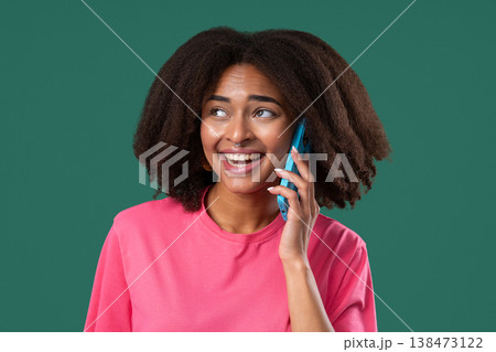 Young African Woman Talking By Cell Phone, Smiling On Green. Smartphone Call Young African Woman Talking By Cell Phone, Smiling On Green. Smartphone Call 138473122