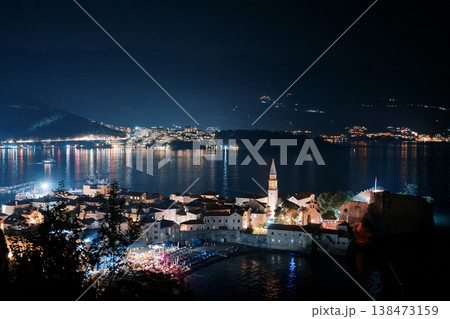 Calm Seaside Town Glowing Under Twilight With Boats And Mountains 138473159