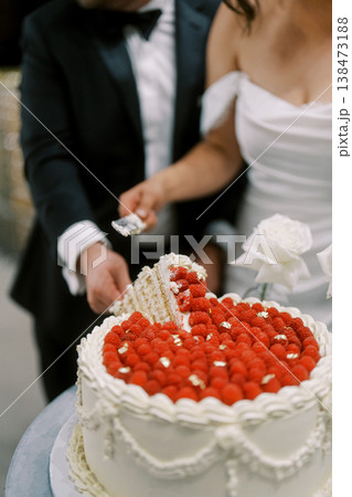Celebratory Moment With Bride And Groom Cutting Decorated Cake Celebratory Moment With Bride And Groom Cutting Decorated Cake 138473188