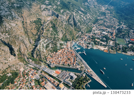 Coastal Harbor Surrounded By Rugged Mountains And Historic Structures 138473233