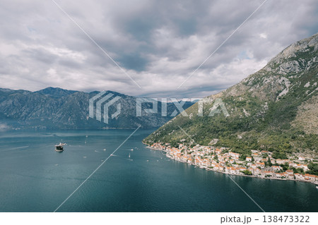 Serene Coastal Hamlet With Colorful Houses And Mountain Views 138473322