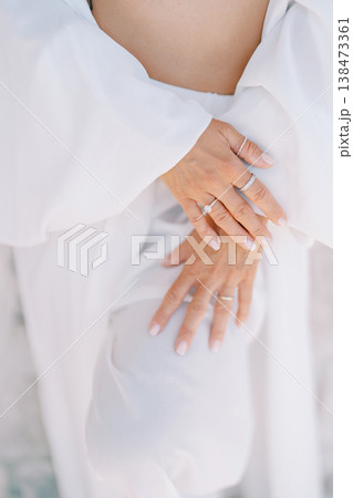 Serene Expecting Mother Holds Belly Softly In Tranquil Light Serene Expecting Mother Holds Belly Softly In Tranquil Light 138473361
