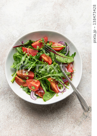 Fresh green salad with tomatoes and red onion 138473428