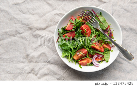Fresh garden salad with tomatoes, arugula, and onion Fresh garden salad with tomatoes, arugula, and onion 138473429