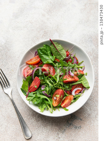 Fresh green salad with tomatoes and red onion 138473430
