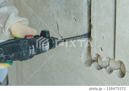 Electrician installing wiring in a modern building under construction 138473572