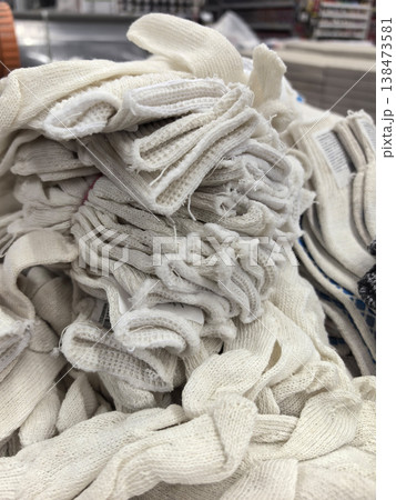 Bundles of white fabric being prepared for crafting in a cozy workshop Bundles of white fabric being prepared for crafting in a cozy workshop 138473581