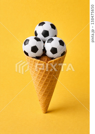 Playful soccer balls in a waffle cone 138475650
