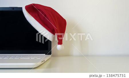Holiday season laptop with Santa hat 138475731