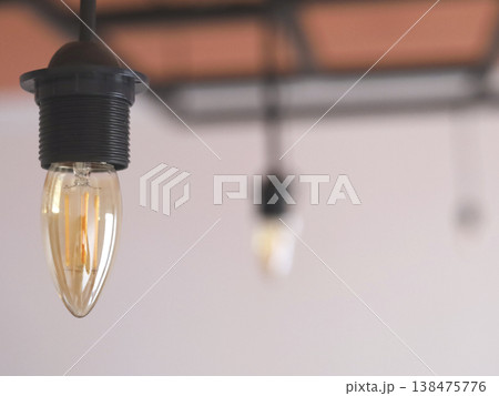 Warm Hanging Filament Bulbs Over Blurred Background 138475776