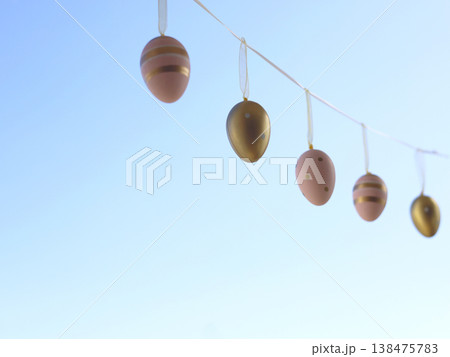 Pastel Easter Eggs Hanging Against Clear Blue Sky Pastel Easter Eggs Hanging Against Clear Blue Sky 138475783