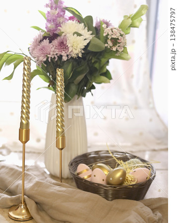 Spring tabletop scene with flowers and candles Spring tabletop scene with flowers and candles 138475797