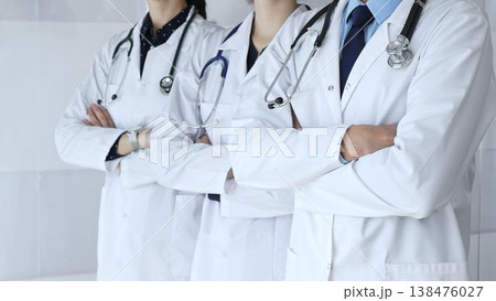 A group of doctors with folded arms demonstrates the professionalism of medicine, mutual support of clinics, and dedication to expert care in a hospital setting A group of doctors with folded arms demonstrates the professionalism of medicine, mutual support of clinics, and dedication to expert care in a hospital setting 138476027