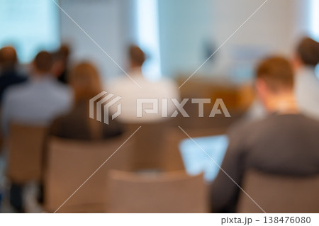 Back view of an audience sitting in chairs at a business conference Back view of an audience sitting in chairs at a business conference 138476080
