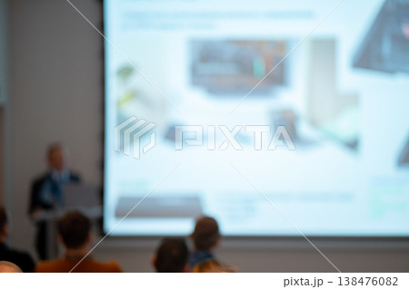 Blurred business presentation with speaker and audience Blurred business presentation with speaker and audience 138476082