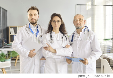 Confident medical team of doctors with stethoscopes in modern clinic office portrait 138480616