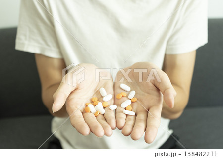 Teen boy have many pills in his hands.. Takes medication for illness Teen boy have many pills in his hands.. Takes medication for illness 138482211