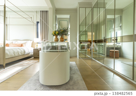 Luxury modern walk-in closet with mirror cabinets facades and island console. 138482565