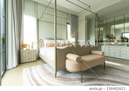 Interior view of King Size Canopy Bed Frame with pillows in elegant bedroom. Honeymoon suite bedroom in pastel and pink color  138482621