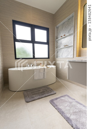 Bathroom interior, modern spacious white bathtub by the window. 138482641