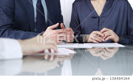 Business people reviewing contract terms during a meeting, negotiating and making decisions together. Business people concept, close up 138484164